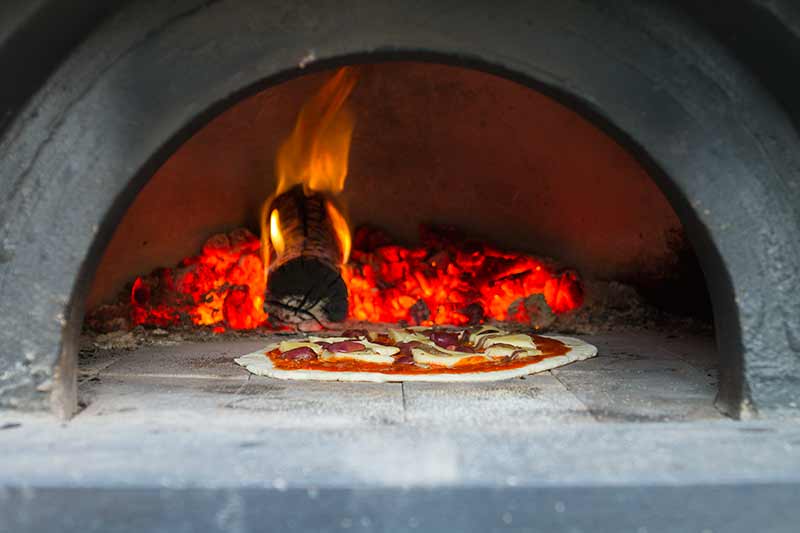 Rendered pizza oven base with tiled bench