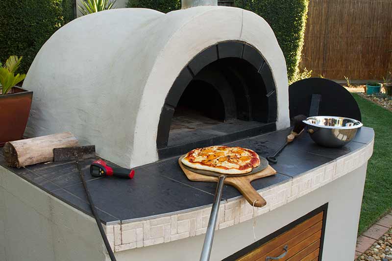 Interior of hot pizza oven showing light clay dome