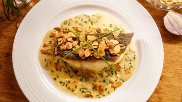 Crispy skin fish almondine with cream sherry sauce and crunchy almonds