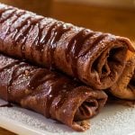I made this for pancake day or Shrove Tuesday, but why wait all year to eat pancakes! I love pancakes and I could eat them all year round. These are crepes made with chocolate and filled with a creamy coconut filling. Serve them hot with hot chocolate sauce.