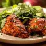 A delicious BBQ style chili chicken recipe made with smoky bell pepper chili based sauce. Roasted using one pan and a blender. It also adapts well to a closed lid style BBQ. Simple to make, and if you make this the day before, it’s even better as the sauce works like a marination. The sauce is made using red bell peppers or capsicums, they are charred black and peeled. Watch the video to see how to peel them. Make extra as these are delish in salads or any meal. Make sure you cook it long enough to get a few black burnt bits on top. So tasty! Serve it with a crispy fresh salad, rice or potatoes. Enjoy my smoky bell pepper chili chicken.