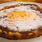 This recipe is based on the Corsican Fiadone or Fiadoni cheesecake which has no bottom layer. That’s what makes it so simple to make, 10 to 15 minutes maximum. What other cheesecake is that quick! I’ve also added blueberries in the filling so there’s no need to top with anything else except a little icing or powdered sugar. This custard style cake needs to be served cold or room temperature. The Corsican version is usually made with goat’s milk ricotta called “Brocciu” which is stronger in flavour. But any similar cheese will work. You need to use drained ricotta otherwise simply place the fresh cheese in a muslin cloth over a colander and refrigerate a few hours to drain the liquid. The alcohol is optional, but using the zest of two lemons is not, you need that strong lemony flavour to cut through the richness. Ensure there’s still a little wobble in the centre once cooked. One of the simplest cheesecake you can make and so delicious! Enjoy my Baked Ricotta Cheesecake With blueberries.