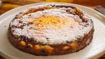 This recipe is based on the Corsican Fiadone or Fiadoni cheesecake which has no bottom layer. That’s what makes it so simple to make, 10 to 15 minutes maximum. What other cheesecake is that quick! I’ve also added blueberries in the filling so there’s no need to top with anything else except a little icing or powdered sugar. This custard style cake needs to be served cold or room temperature. The Corsican version is usually made with goat’s milk ricotta called “Brocciu” which is stronger in flavour. But any similar cheese will work. You need to use drained ricotta otherwise simply place the fresh cheese in a muslin cloth over a colander and refrigerate a few hours to drain the liquid. The alcohol is optional, but using the zest of two lemons is not, you need that strong lemony flavour to cut through the richness. Ensure there’s still a little wobble in the centre once cooked. One of the simplest cheesecake you can make and so delicious! Enjoy my Baked Ricotta Cheesecake With blueberries.