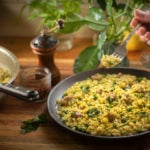 A simple risotto made with Italian sausage, peas and saffron spice. A good risotto should be creamy without cream and cooked al dente like pasta. Nothing worse than a gluggy risotto. It should also be a little runny once served, and not in clumps. This recipe uses freshly made chicken stock; this step is optional but recommended as your risotto is only as good as your stock. I never buy stocks and I always buy whole chickens. The chicken carcass and bones make the most delicious stock and it’s healthy. Bought stocks are full of preservatives, salt and flavour enhancers, some don’t even have chicken! There may be some good ones you can buy but I haven’t seen them yet. Risotto is traditionally a Northern Italian dish, it’s made using a high starch rice such as Arborio or Carnaroli and other rounded short grain rice. Arborio seems to be the most popular, although a lot of Chefs will favour Carnaroli as it’s less likely to get overcooked and retains the al dente texture. For this recipe I used Carnaroli, which works very well and absorbs the liquid easier. The key is to not over cook it, just like a good pasta you want that firm bite and not a soft mash that can result in being gluey. I used Italian sausages which usually contain fennel, this gives the meat pieces a beautiful flavour. The flavour also infuses into the rice. Buy the good cheese and throw in a little or a lot of butter, either way you can’t go wrong. Always serve it immediately but if you can’t, reheat it in a pan with a little water. I like to also drizzle a little olive oil on top before serving. Enjoy risotto with sausage and peas