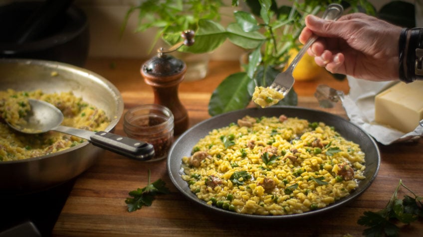 A simple risotto made with Italian sausage, peas and saffron spice. A good risotto should be creamy without cream and cooked al dente like pasta. Nothing worse than a gluggy risotto. It should also be a little runny once served, and not in clumps. This recipe uses freshly made chicken stock; this step is optional but recommended as your risotto is only as good as your stock. I never buy stocks and I always buy whole chickens. The chicken carcass and bones make the most delicious stock and it’s healthy. Bought stocks are full of preservatives, salt and flavour enhancers, some don’t even have chicken! There may be some good ones you can buy but I haven’t seen them yet. Risotto is traditionally a Northern Italian dish, it’s made using a high starch rice such as Arborio or Carnaroli and other rounded short grain rice. Arborio seems to be the most popular, although a lot of Chefs will favour Carnaroli as it’s less likely to get overcooked and retains the al dente texture. For this recipe I used Carnaroli, which works very well and absorbs the liquid easier. The key is to not over cook it, just like a good pasta you want that firm bite and not a soft mash that can result in being gluey. I used Italian sausages which usually contain fennel, this gives the meat pieces a beautiful flavour. The flavour also infuses into the rice. Buy the good cheese and throw in a little or a lot of butter, either way you can’t go wrong. Always serve it immediately but if you can’t, reheat it in a pan with a little water. I like to also drizzle a little olive oil on top before serving. Enjoy risotto with sausage and peas