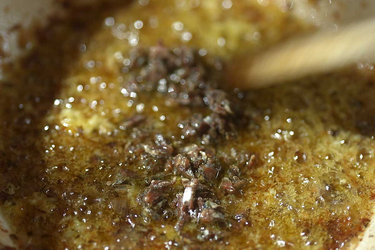 Anchovies melting into sauce