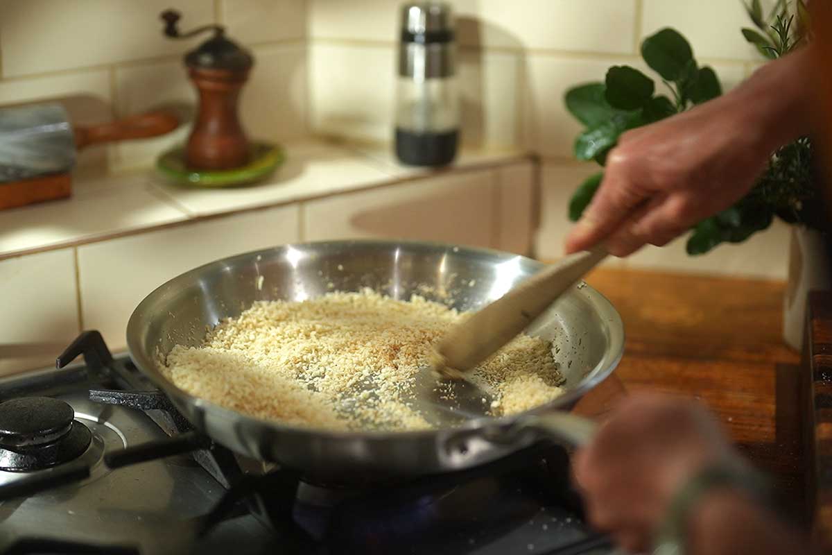 Panko parmesan crumb toasting golden in frying pan