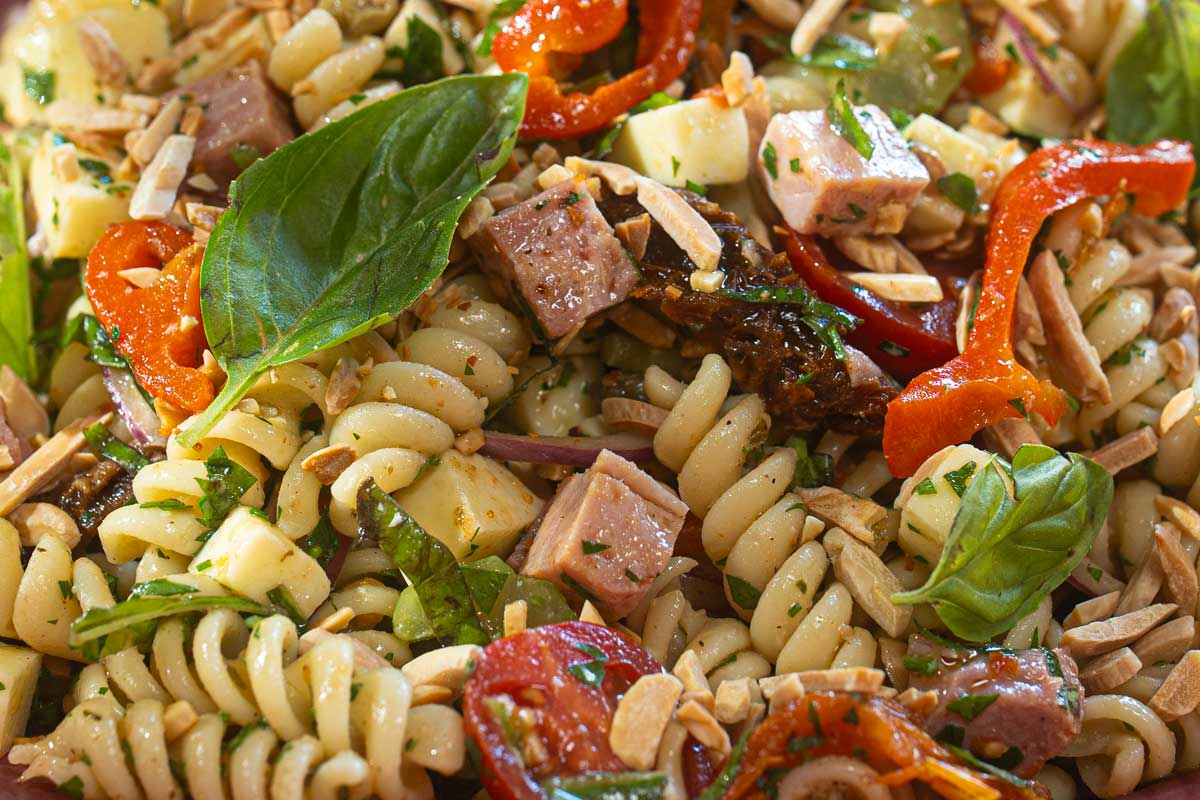 Close up of pasta salad with anchovy caper dressing soaked into fusilli
