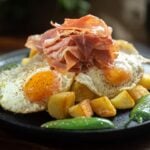 Crispy Potatoes with Broken Eggs and Serrano Ham