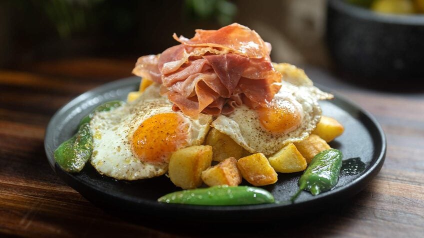 Crispy Potatoes with Broken Eggs and Serrano Ham
