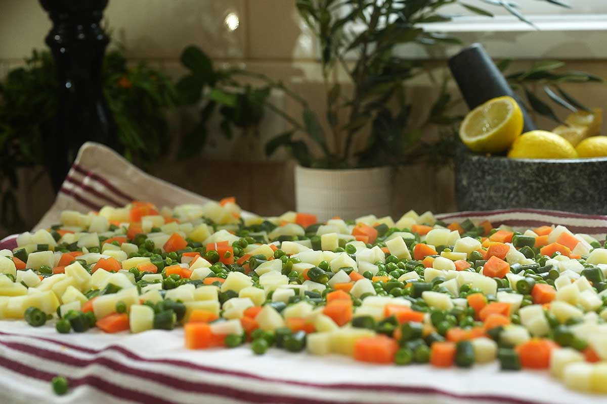 Close up of the vegetables spread out on a tea towel, drying before being folded through the mayonnaise