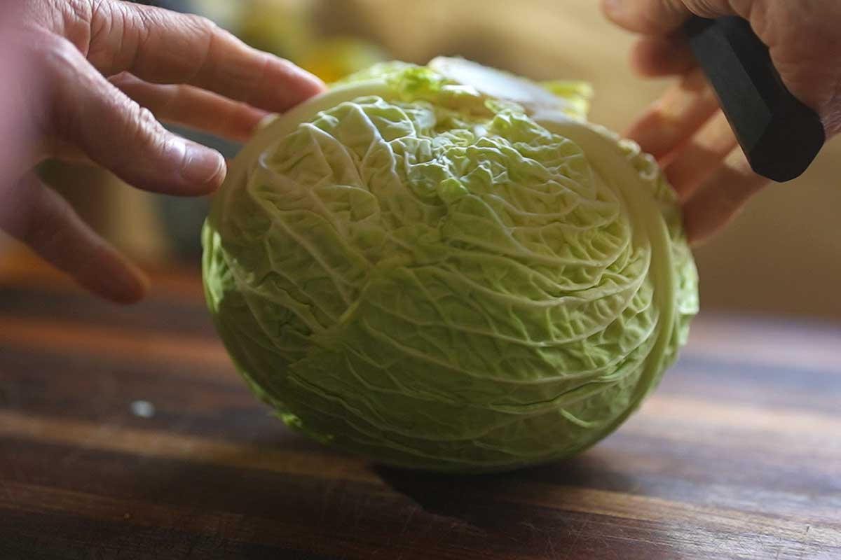 Whole cabbage&nbsp; on a wooden board before cooking