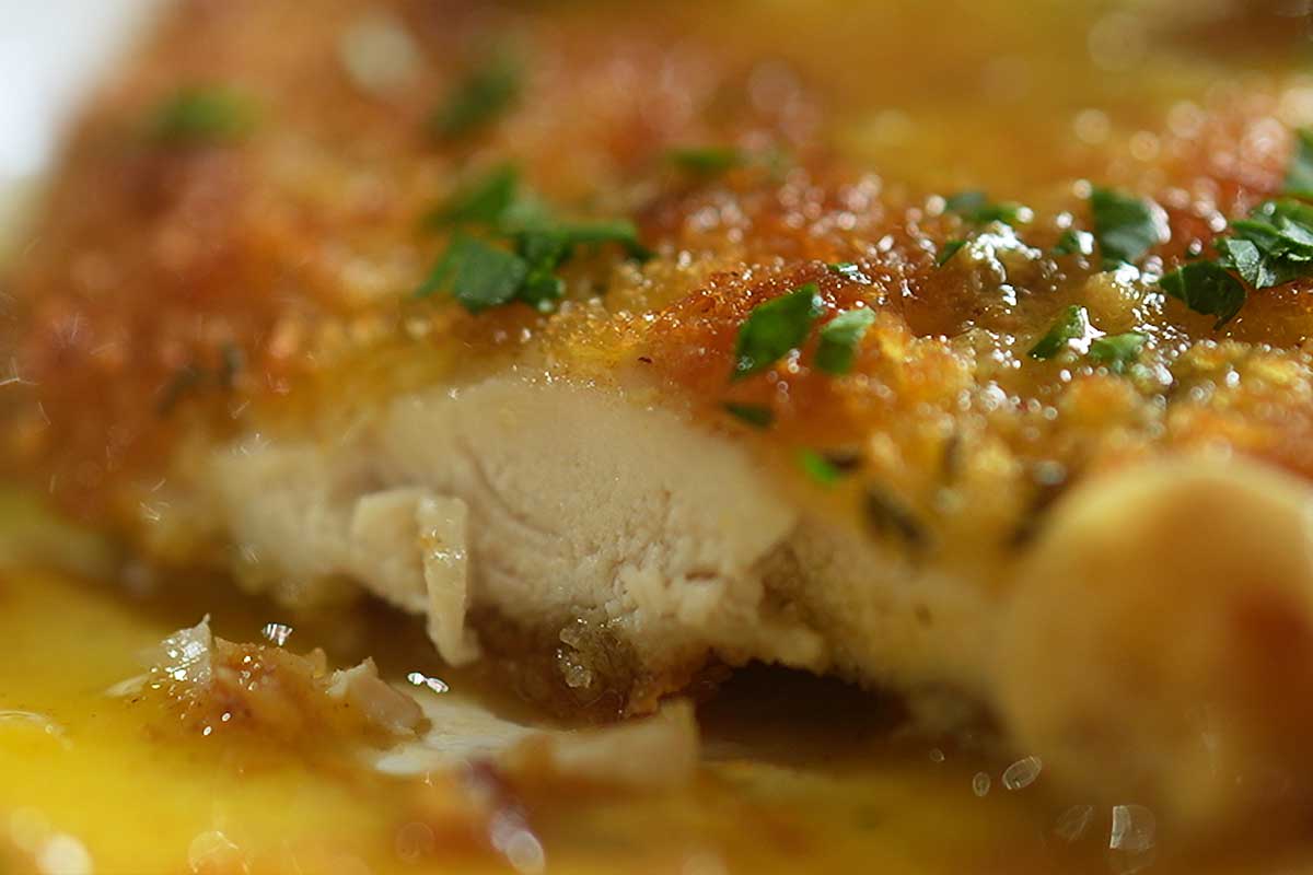 Close up of the crispy panko crust cross section showing the juicy chicken inside