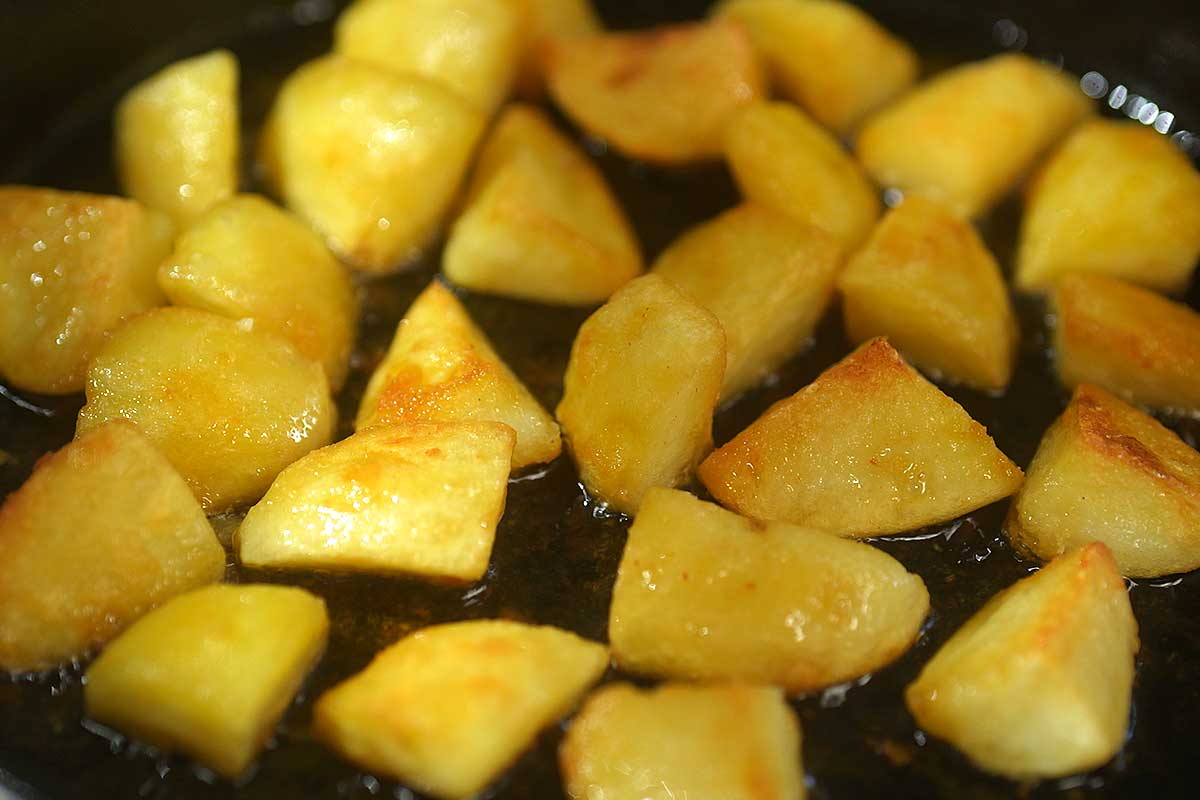 Potatoes deeply golden and blistered in the second fry