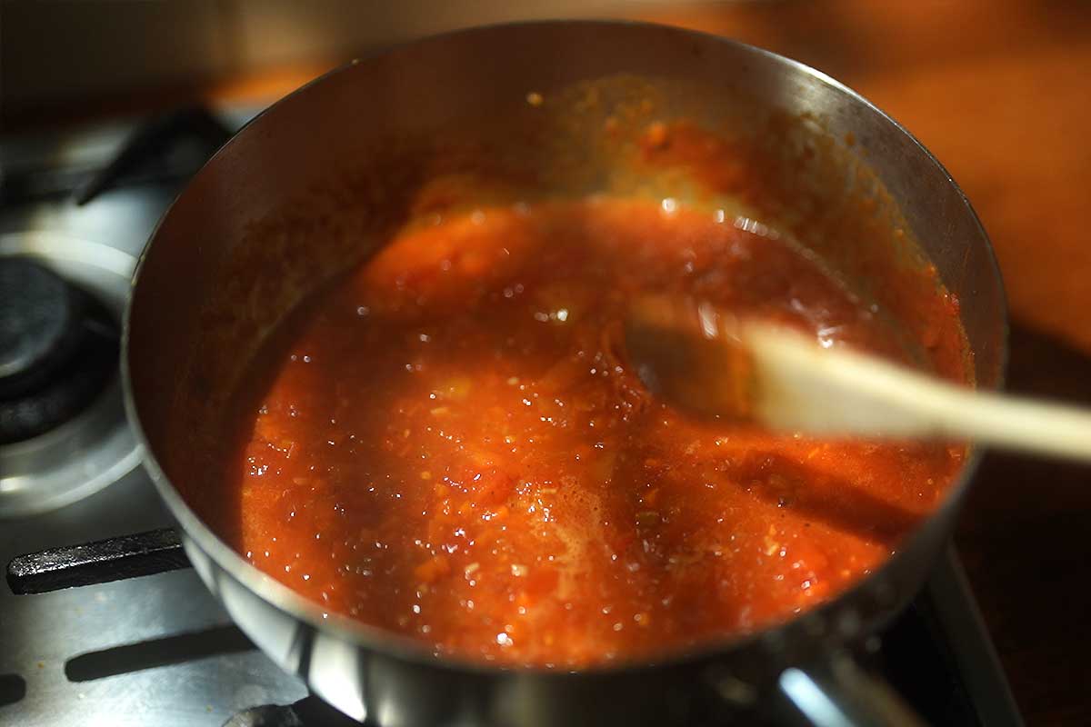 Tomato sauce reducing and thickening in the frying pan
