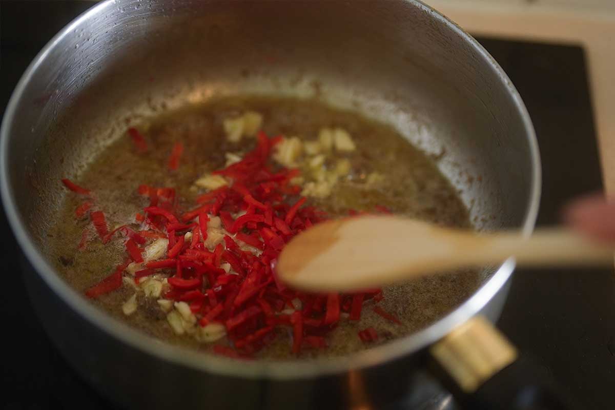 Garlic and chilli slices sizzling gently in the anchovy butter