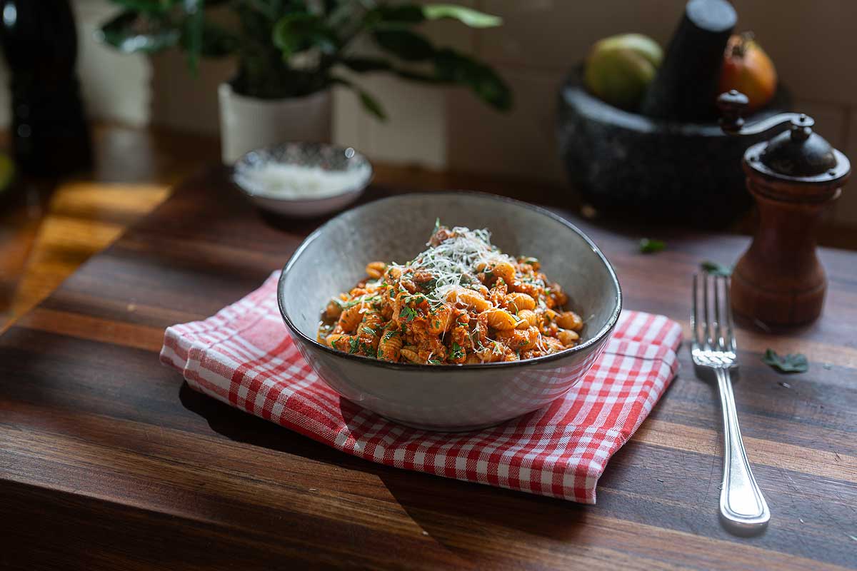 Malloreddus alla Campidanese plated with extra pecorino and parsley